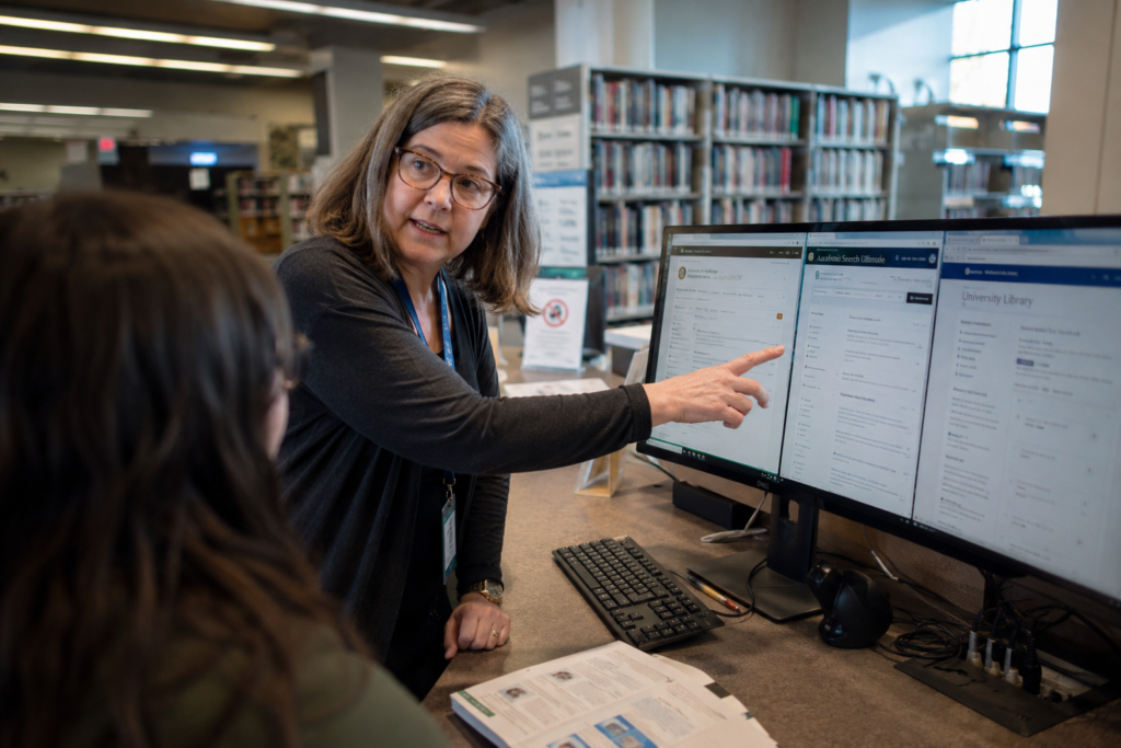 Librarian demonstrating lateral reading across multiple browser tabs to verify a claim